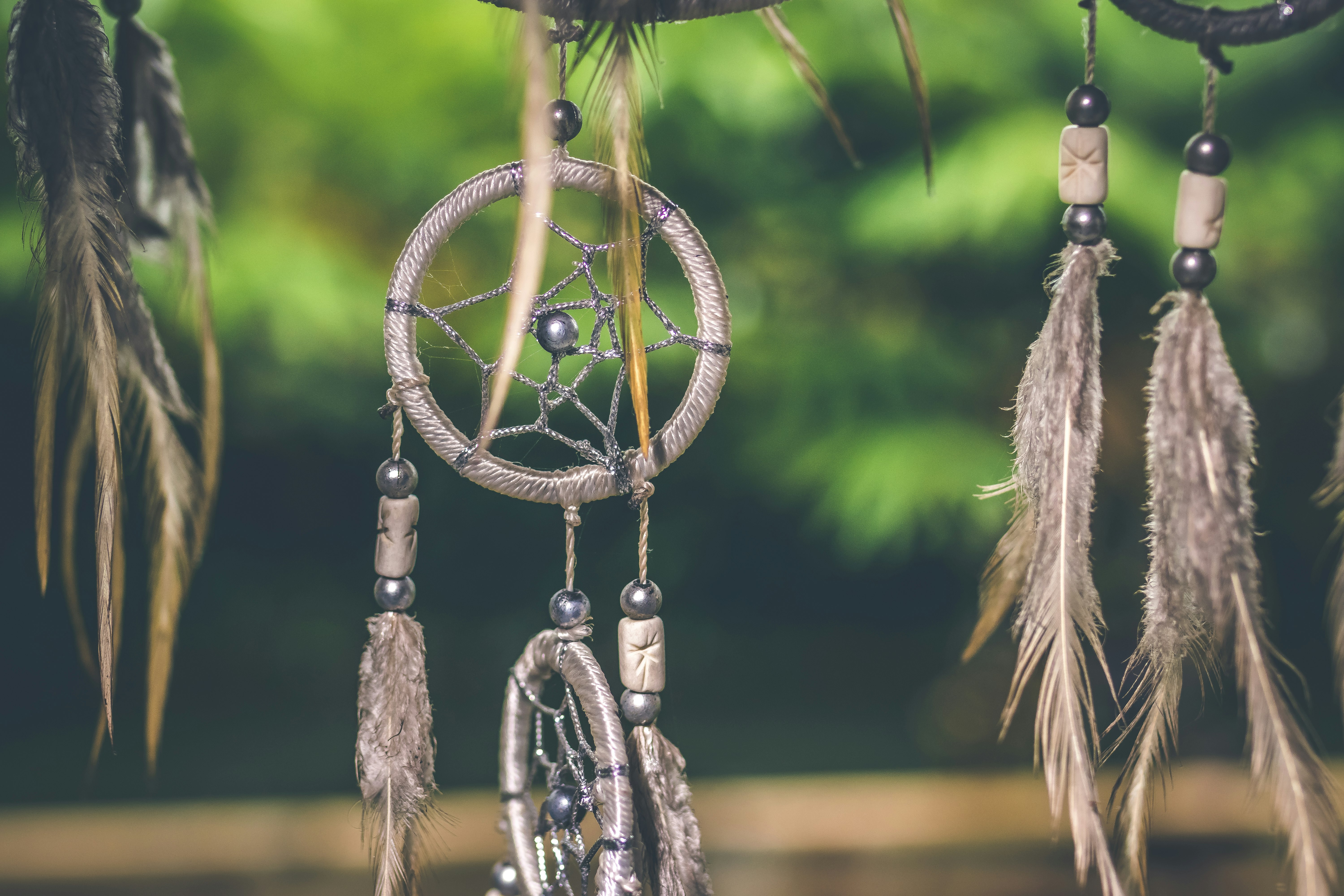 close-up photo of gray dreamcatcher pendants